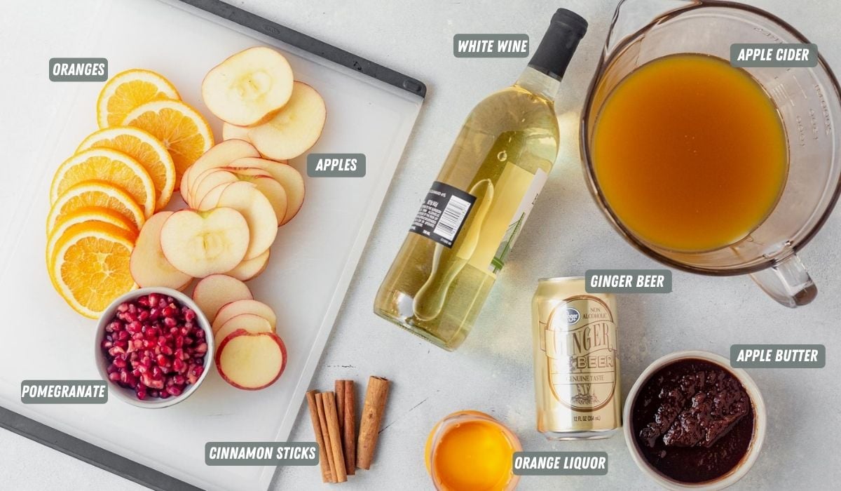 ingredients for apple cider sangria measured out on a table