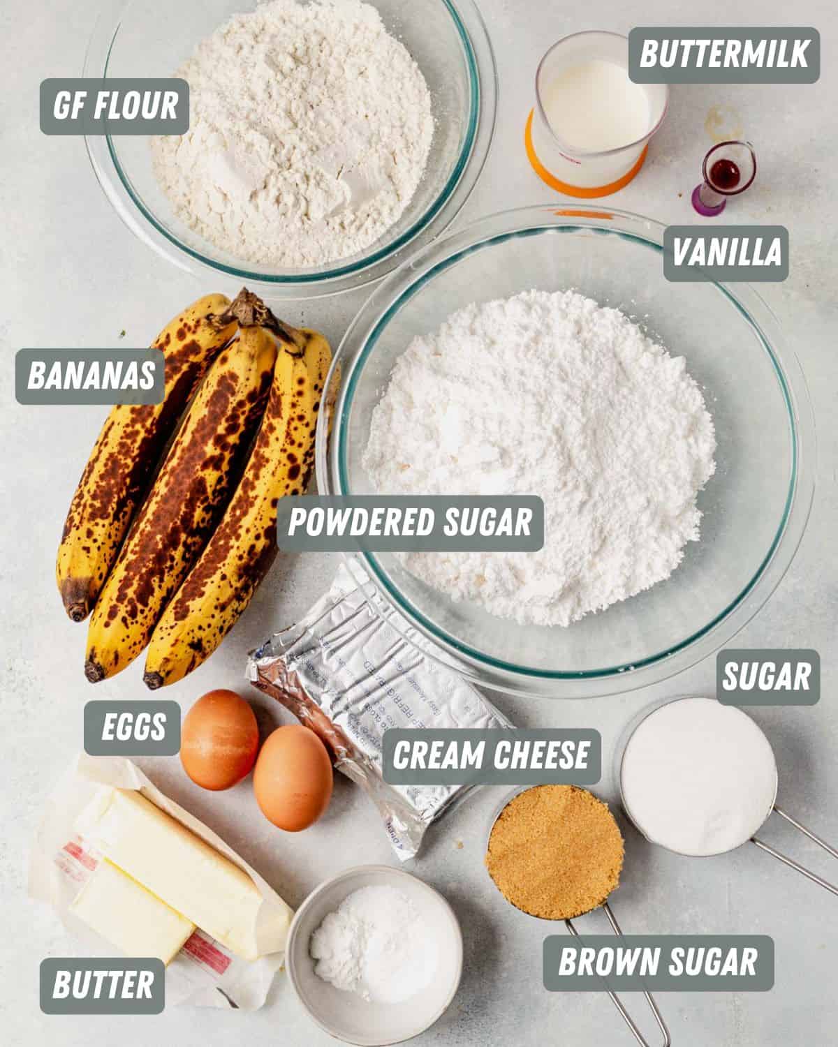ripe bananas, gluten free flour, eggs, sugar, butter, buttermilk and vanilla measured on a table