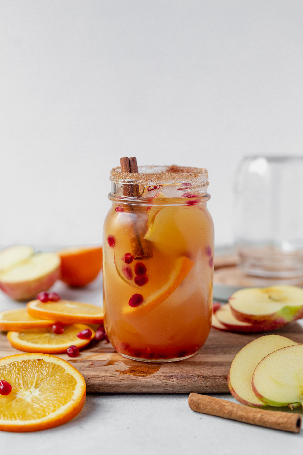 apple cider sangria in a mason jar with cinnamon sticks