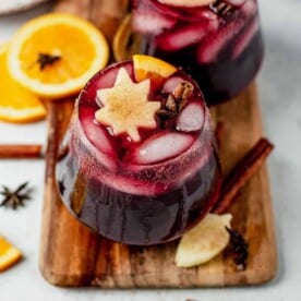 a glass of thanksgiving sangria with apples and a cinnamon stick