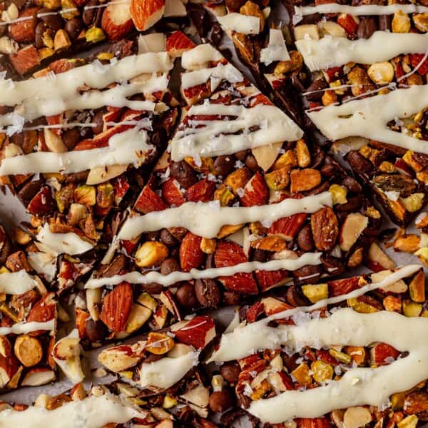 nuts and coffee bean bark with white chocolate drizzle broken into pieces