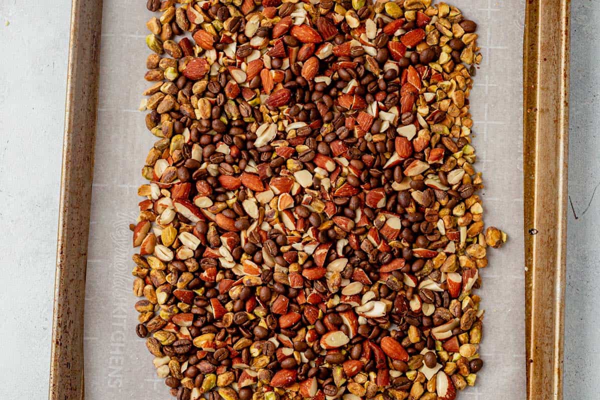 coffee beans, almonds, and pistachios on parchment paper