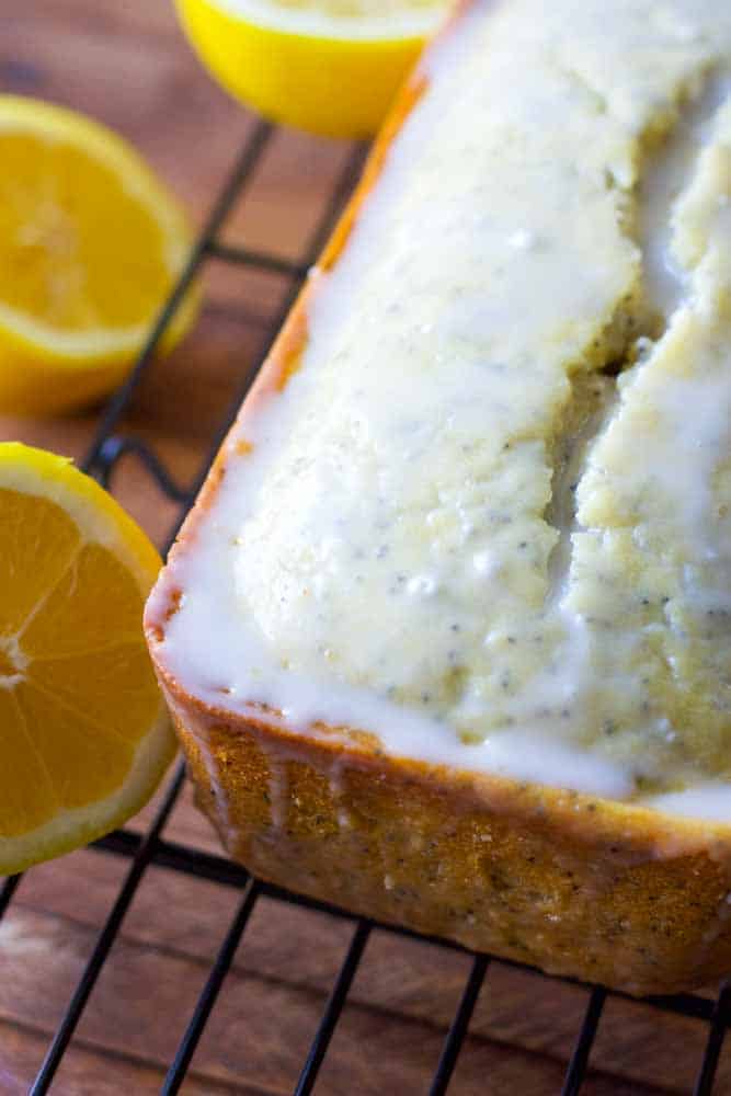 loaf of lemon poppy seed bread resting on a cooling rack