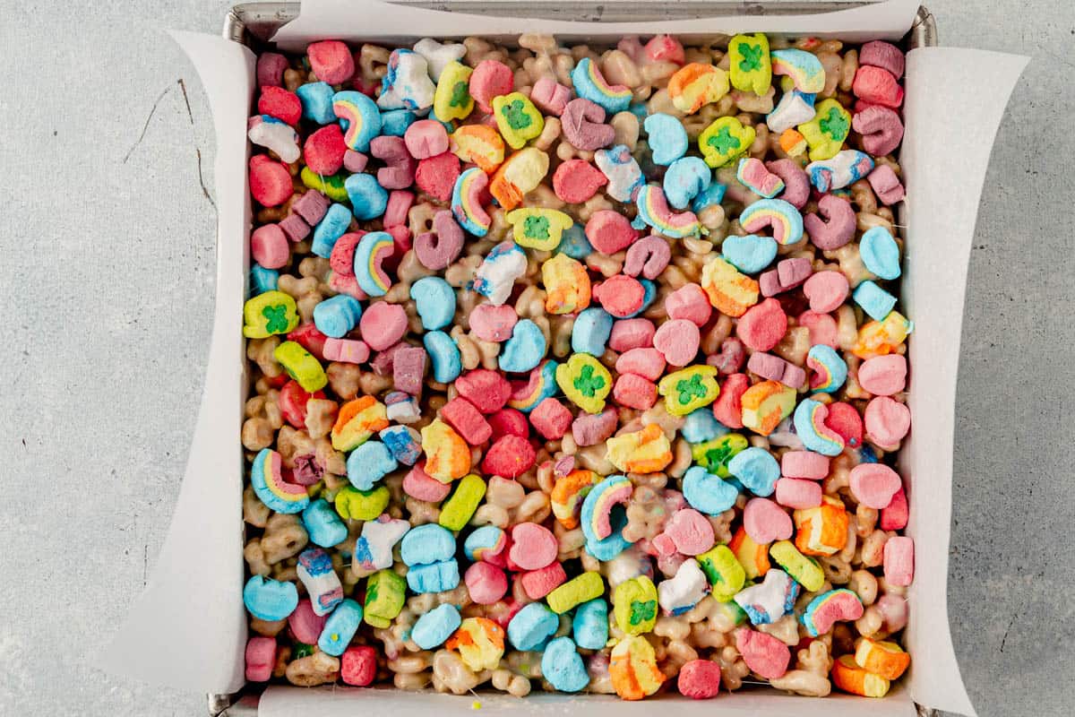 lucky charms rice krispie treats in a parchment line square pan
