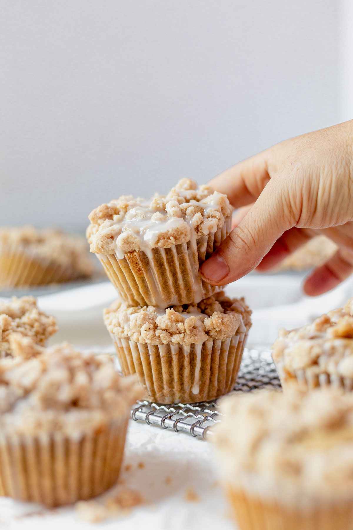 two coffee cake muffins stacked on top of each other with icing dripping down