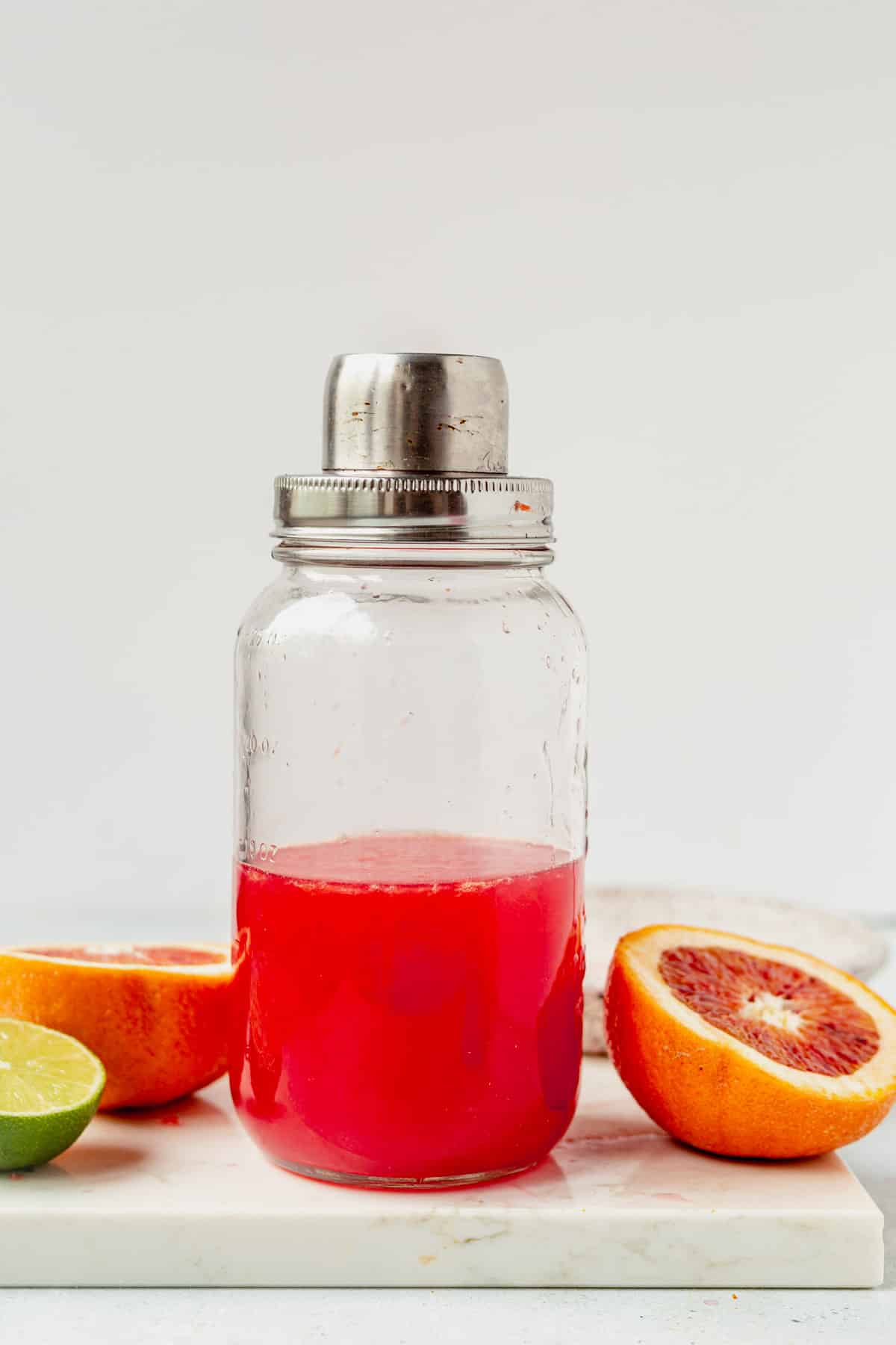 vibrant blood orange margarita in a cocktail shaker