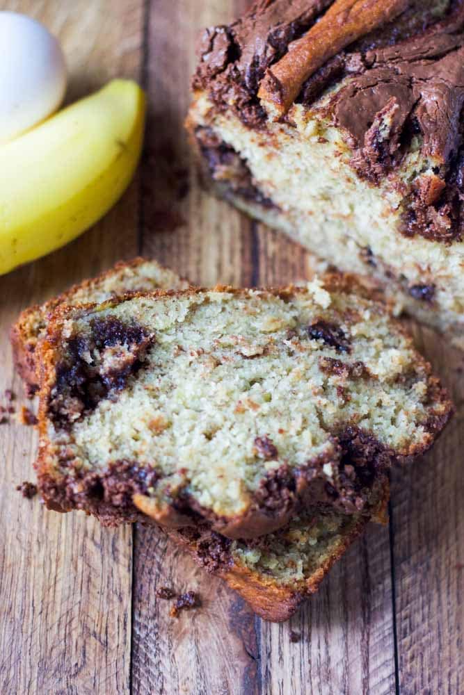 a slice of banana bread with nutella marbling on a cutting board