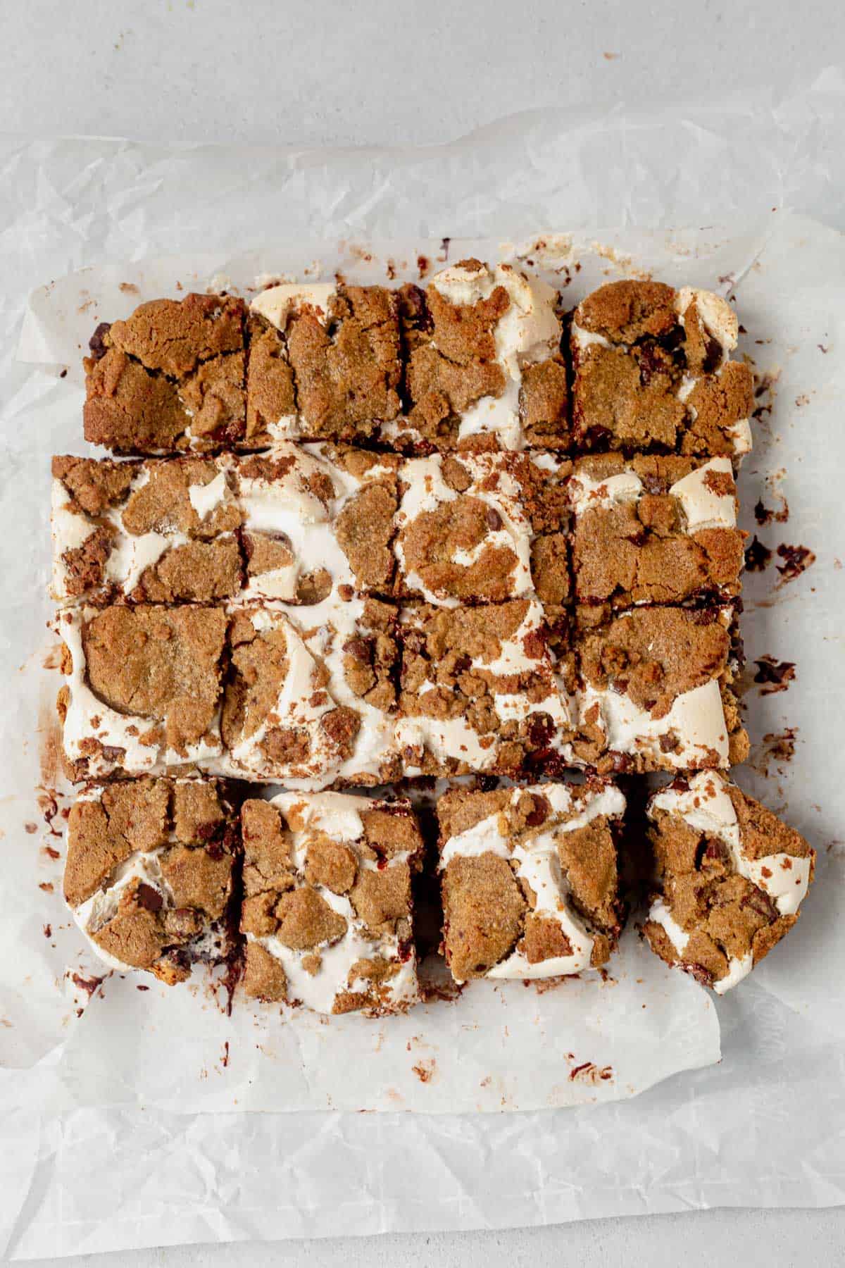 16 cookies smores bars cut into squares on parchment paper