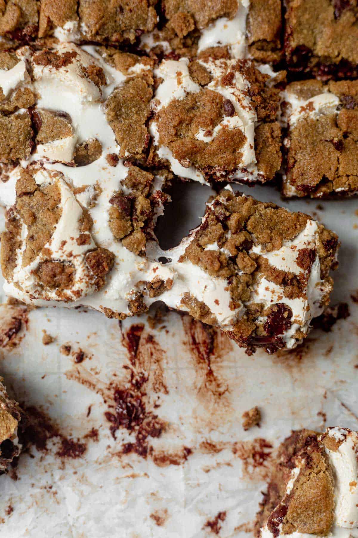pulling a cookie smores bar from the baking dish