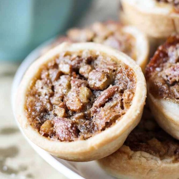 derby day pecan mini pies stacked on a plate