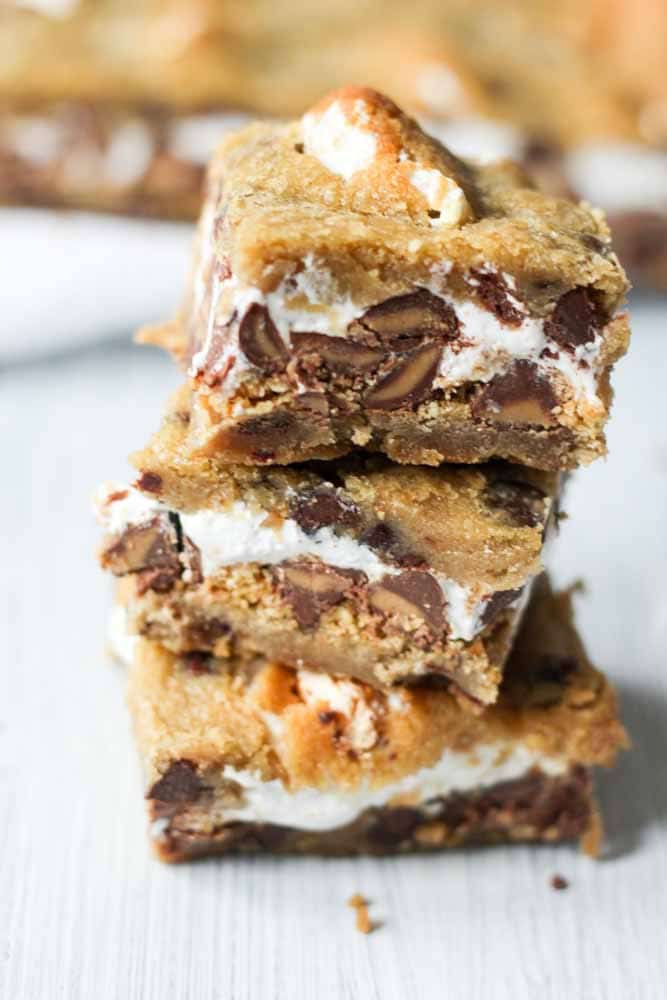 What do you get when you put chocolate peanut butter chips, marshmallow fluff and graham crackers between two cookies? Death by delicious. And also chocolate chip cookie s'mores bars.
