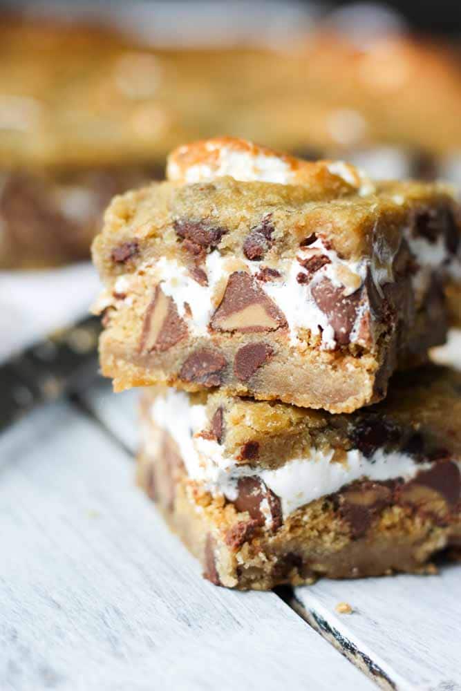 What do you get when you put chocolate peanut butter chips, marshmallow fluff and graham crackers between two cookies? Death by delicious. And also chocolate chip cookie s'mores bars.
