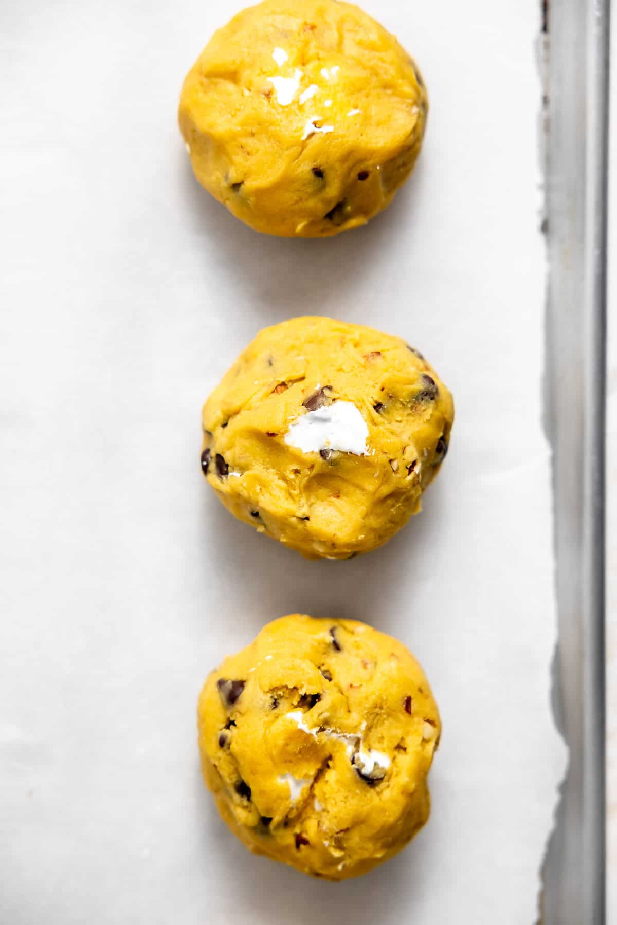 rocky road cookie dough balls on a baking sheet