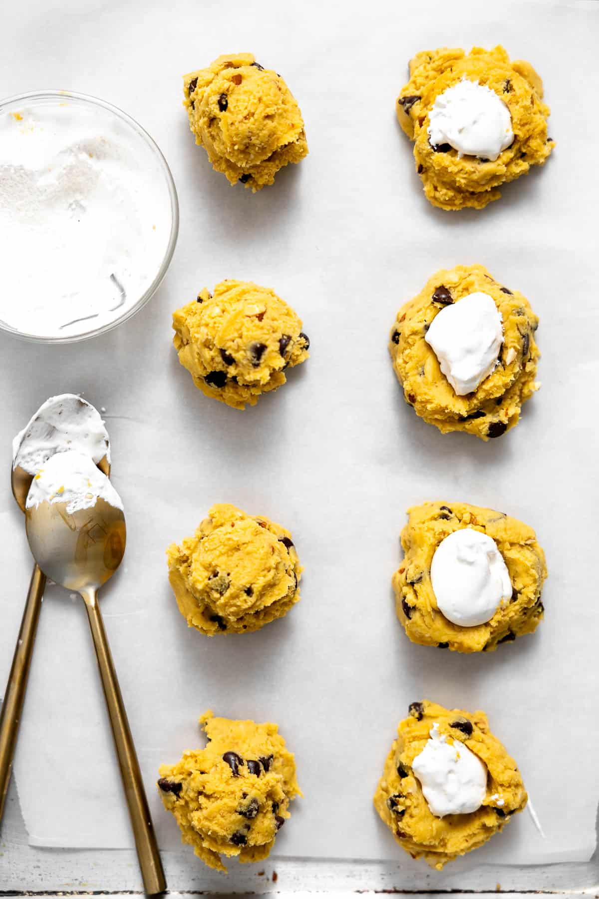 adding marshmallow fluff to the center of cookie dough