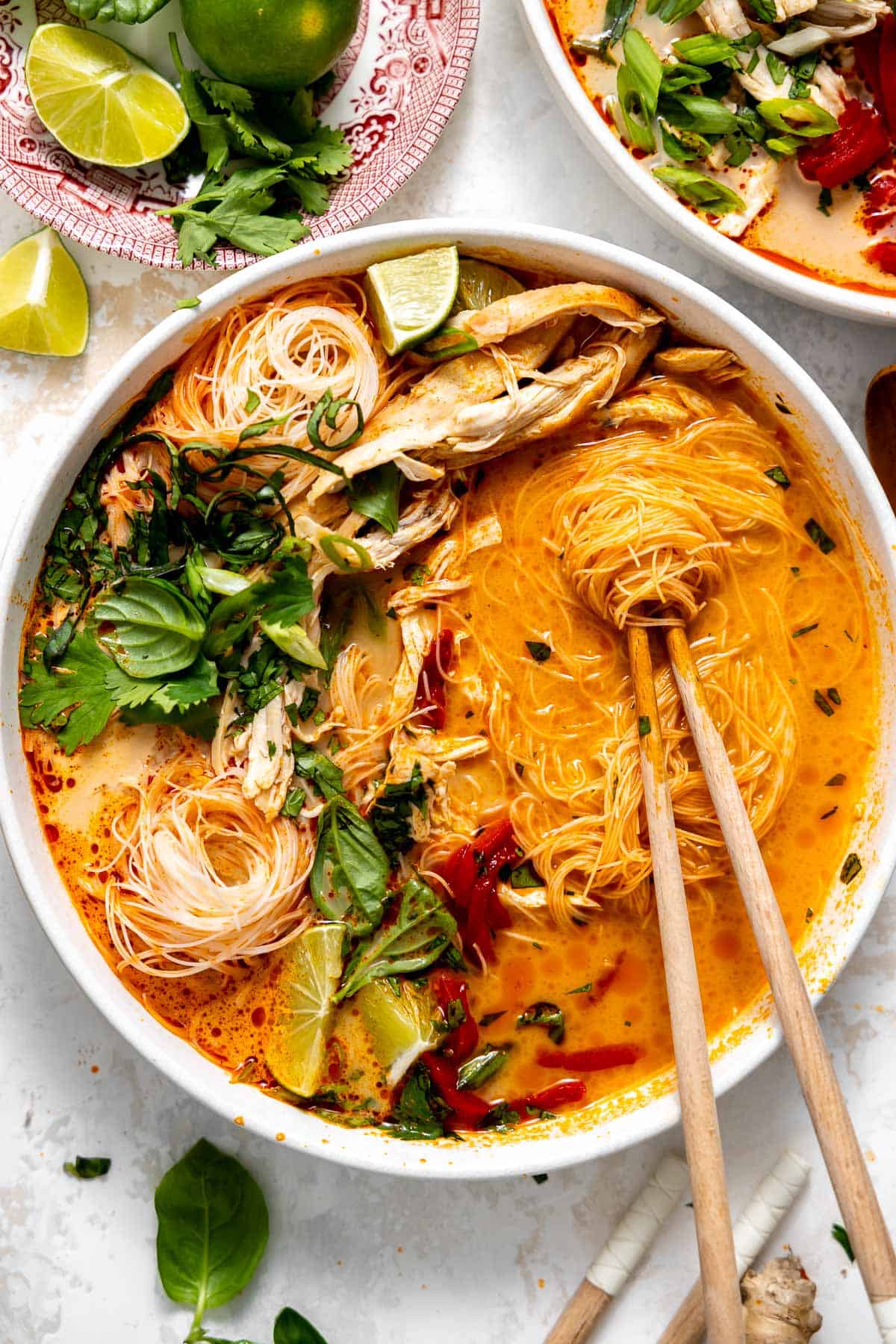 thai curry noodle soup i a bowl with chopsticks