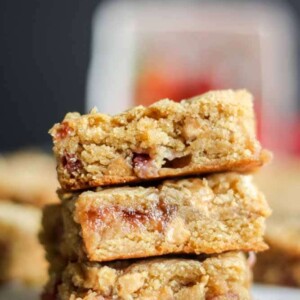 three peanut butter and jelly blondies stacked