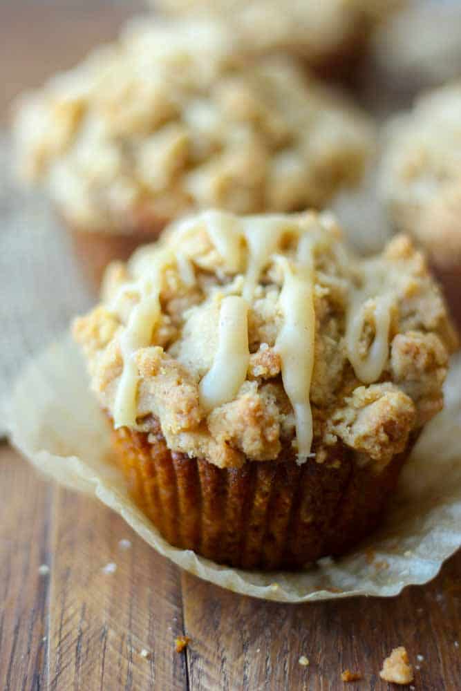 pumpkin muffin with streusel unwrapped with icing on top