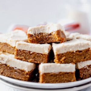 a bite taken out of a paleo pumpkin bar on a serving tray