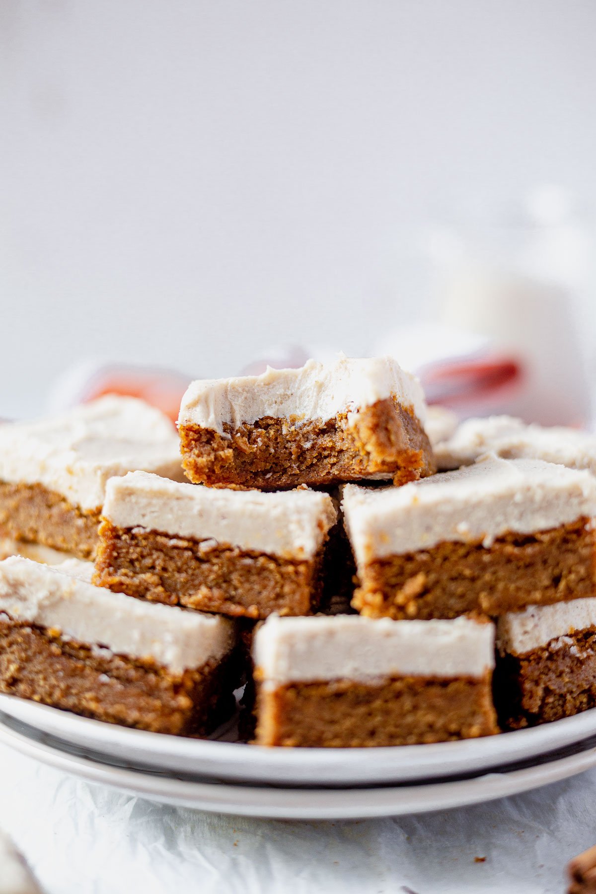 paleo pumpkin bars cut into squares and stacked on a serving plate