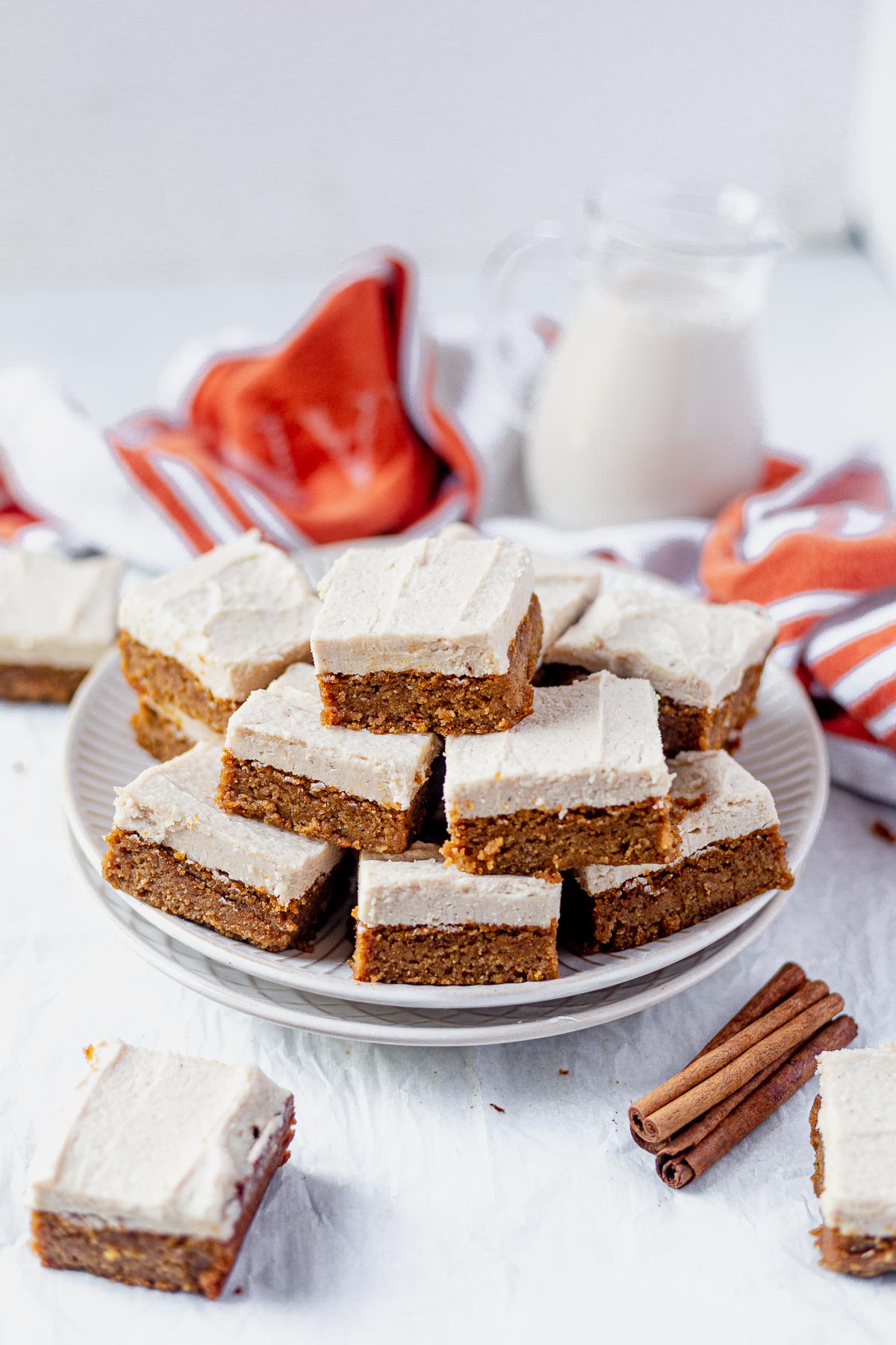 paleo pumpkin bars on a serving tray with a glass of milk