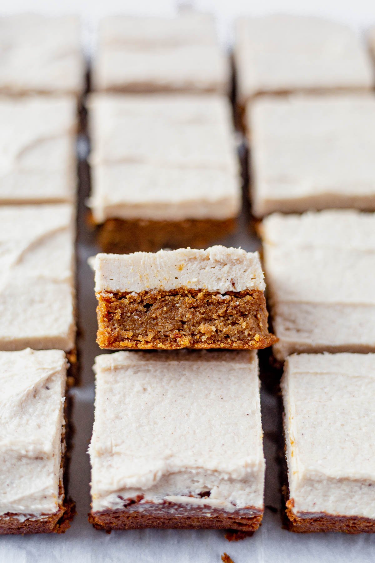 paleo pumpkin bars cut into squares on parchment paper