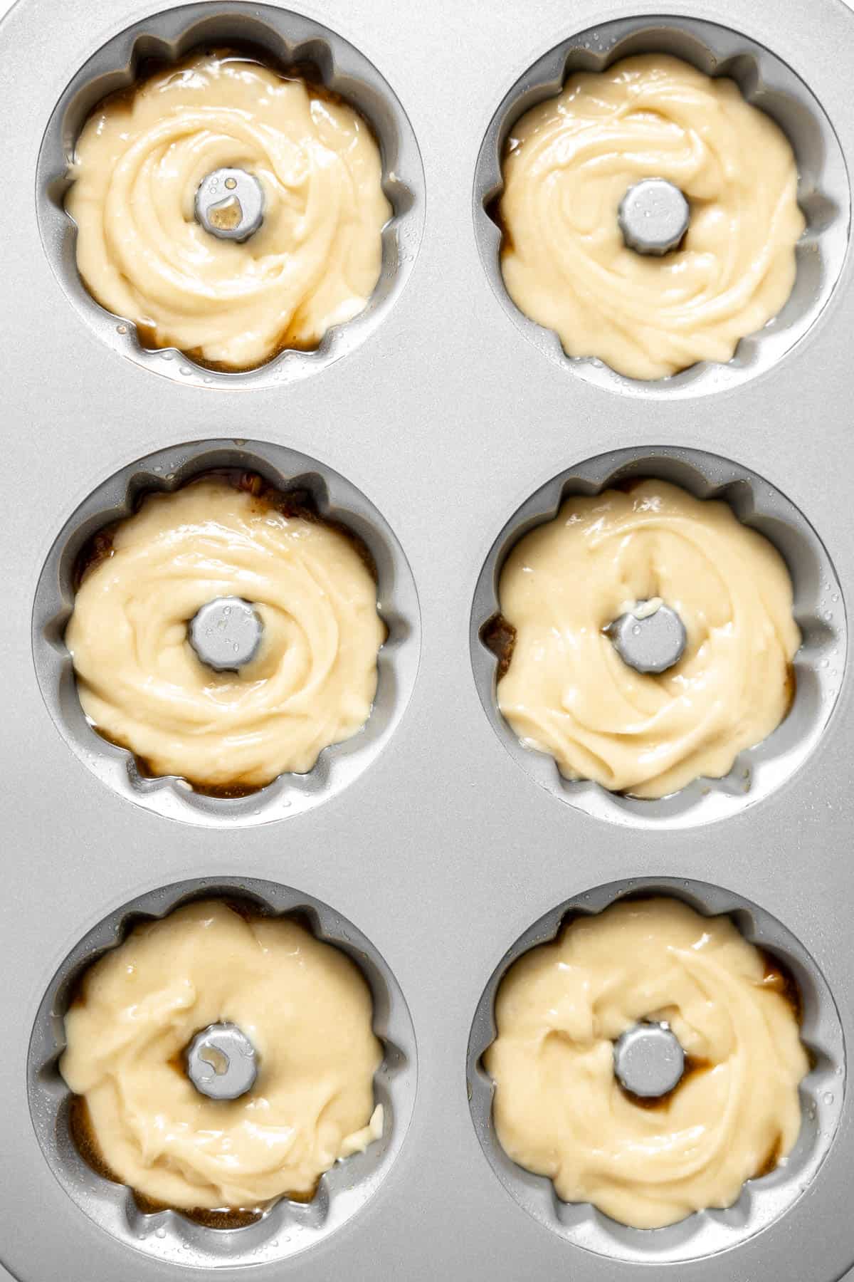 mini apple cake batter in a mini bundt pan.