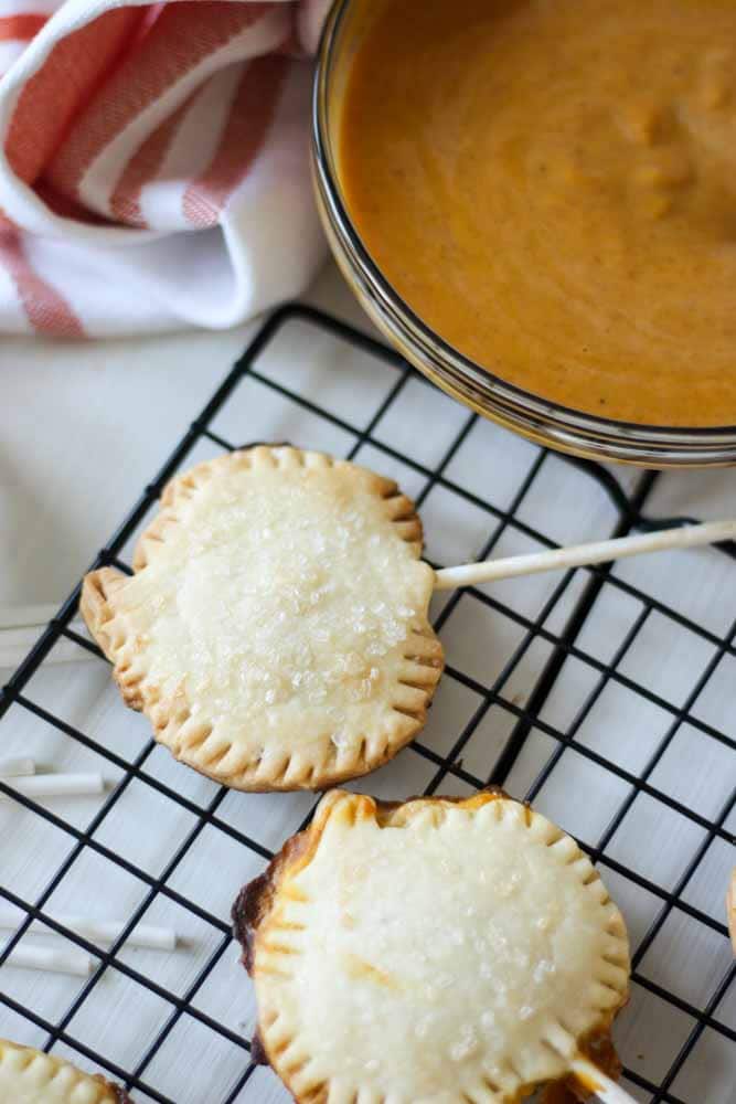 Pumpkin Pie Pops are the perfect thanksgiving dessert recipe! Use premade pie crust to cut out pumpkin shaped dough and fill with pumpkin pie filling. Bake with a stick and you have the perfect mini bite-size dessert for fall that everyone will love. The best part is they're individual so everyone can have one and eat whenever they want.