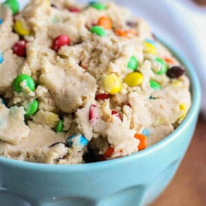 monster cookie dough with m&ms in a turquoise bowl on a counter