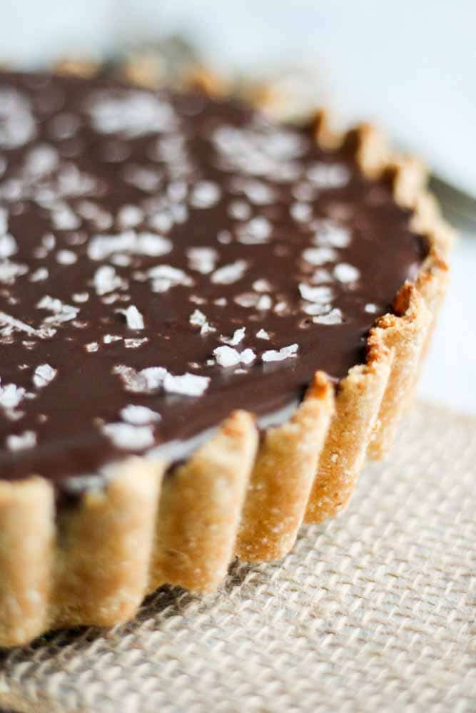 This chocolate caramel tart is paleo, gluten-free and vegan! Made with whole natural ingredients, this tart recipe is naturally sweet and satisfying.