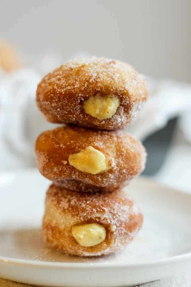 Brioche Doughnuts are the perfect breakfast recipe or dessert recipe to make for a crowd. They're light, crispy and filled with pudding-like vanilla pastry cream. This donut recipe is a classic cream filled doughnut everyone will love.