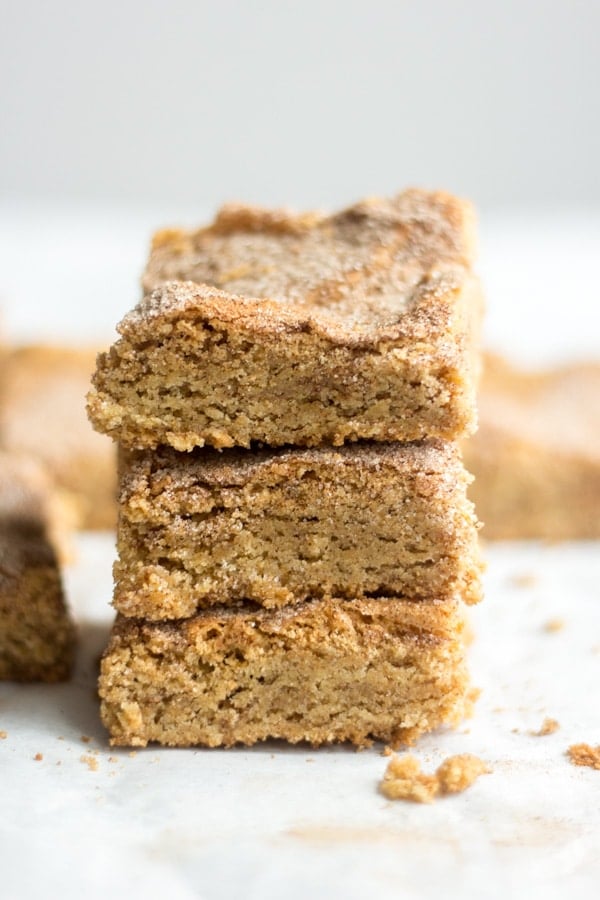 Thick and chewy, these gluten free snickerdoodle blondies are filled with all the flavor and texture you crave from a blondie recipe but don't include any of the gluten. They're filled with butter and brown sugar and lots of cinnamon sugar. This easy recipe doesn't require any mixer and comes together in under 30 minutes. Cut into squares and serve! Keep in the freezer for up to two months.