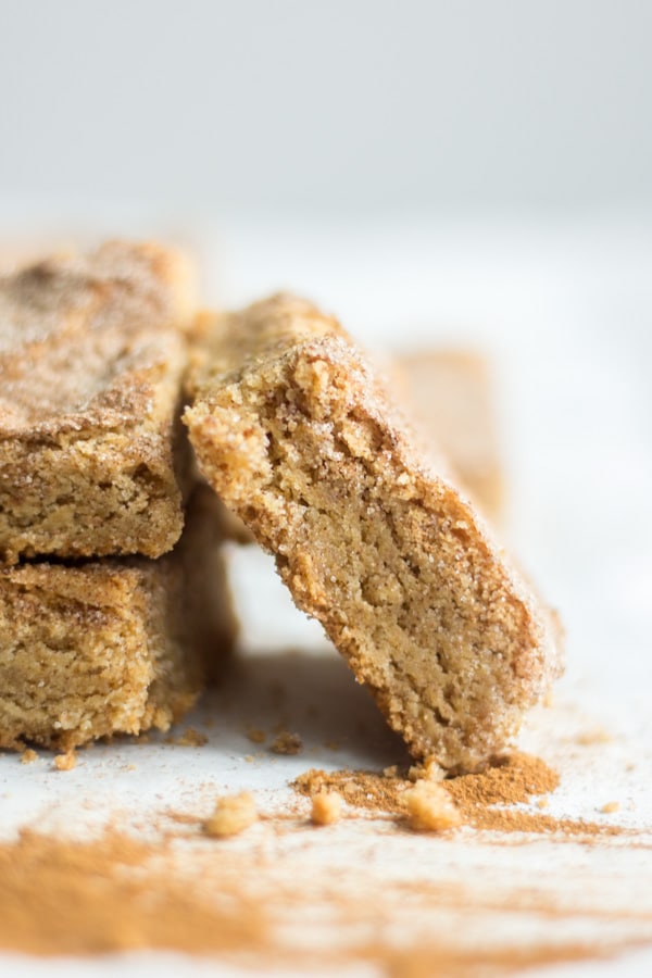 Thick and chewy, these gluten free snickerdoodle blondies are filled with all the flavor and texture you crave from a blondie recipe but don't include any of the gluten. They're filled with butter and brown sugar and lots of cinnamon sugar. This easy recipe doesn't require any mixer and comes together in under 30 minutes. Cut into squares and serve! Keep in the freezer for up to two months.
