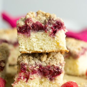 Raspberry Crumb Cake! Crumble fans rejoice because this moist and delicious cake is topped with a sweet and fruity raspberry jam (plus real raspberries) and piled high with cinnamon crumble. It's so easy to make and the perfect morning cake to go with your Valentine's Day brunch.