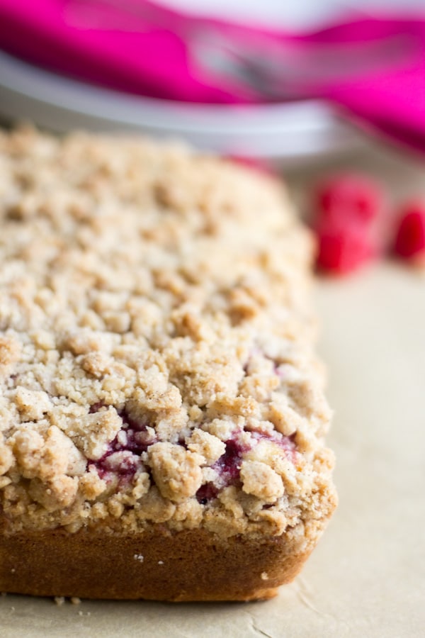 raspberry almond coffee cake on a piece of parchment paper before being cut