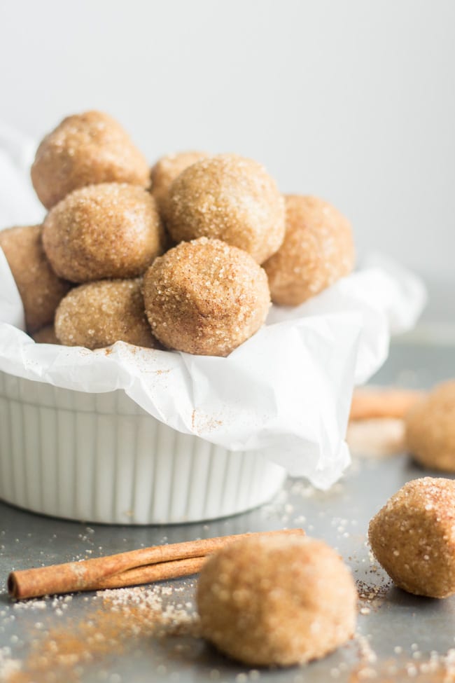 snickerdoodle protein balls rolled in cinnamon and coconut sugar in a white bowl