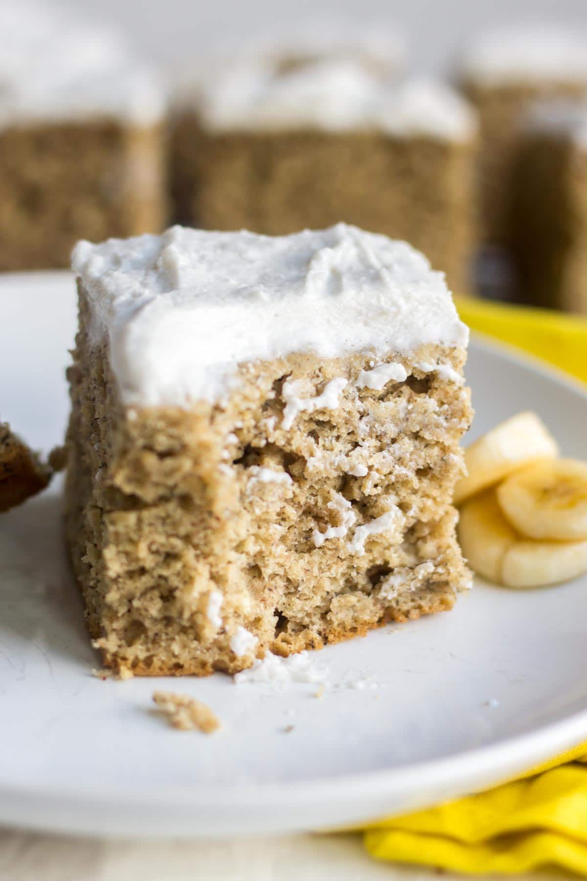 healthy banana cake recipe on a white plate with a bite taken out