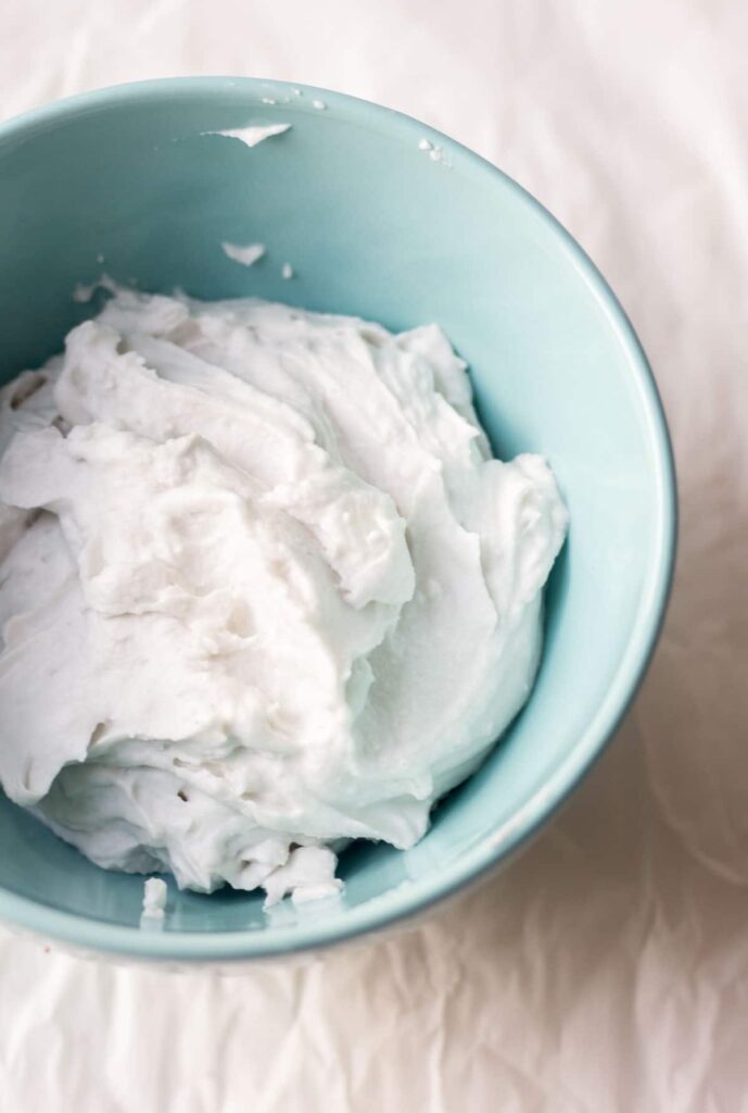coconut whipped cream in a light blue bowl