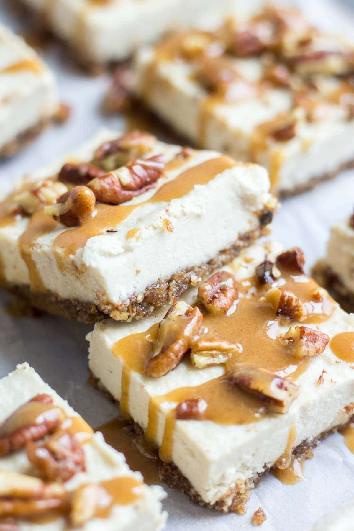 Smooth and creamy, these turtle vegan cheesecake bars are an easy and no bake healthy dessert. The crust is made with pecans and dates and the silky vegan cheesecake is topped with paleo caramel and pecans. You won't believe how yummy an easy it is to make!