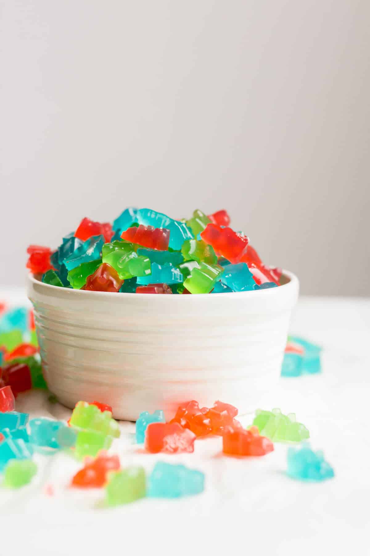 Pre-workout gummies in a white bowl and spilled out onto the counter