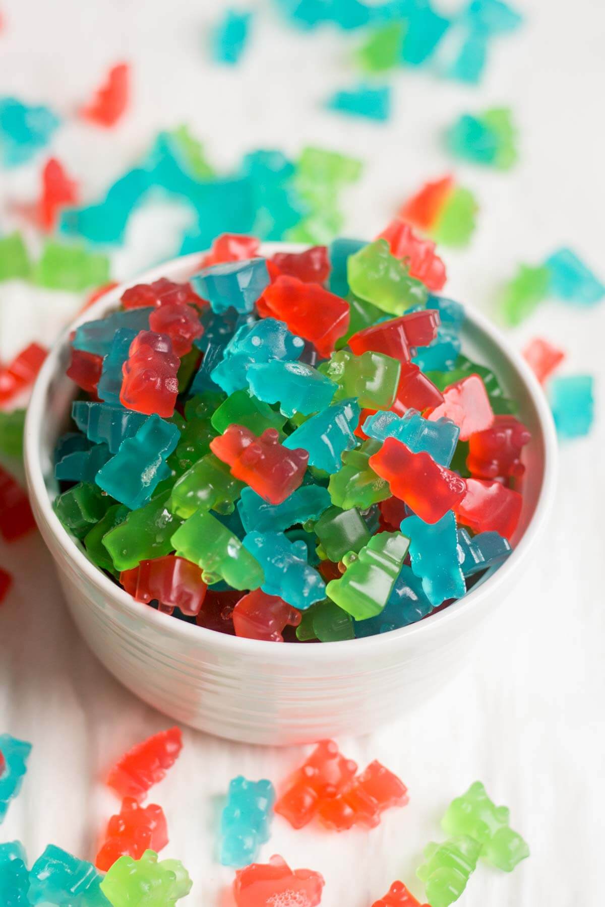 white bowl filled with Pre-workout gummies and more spilling out on the counter