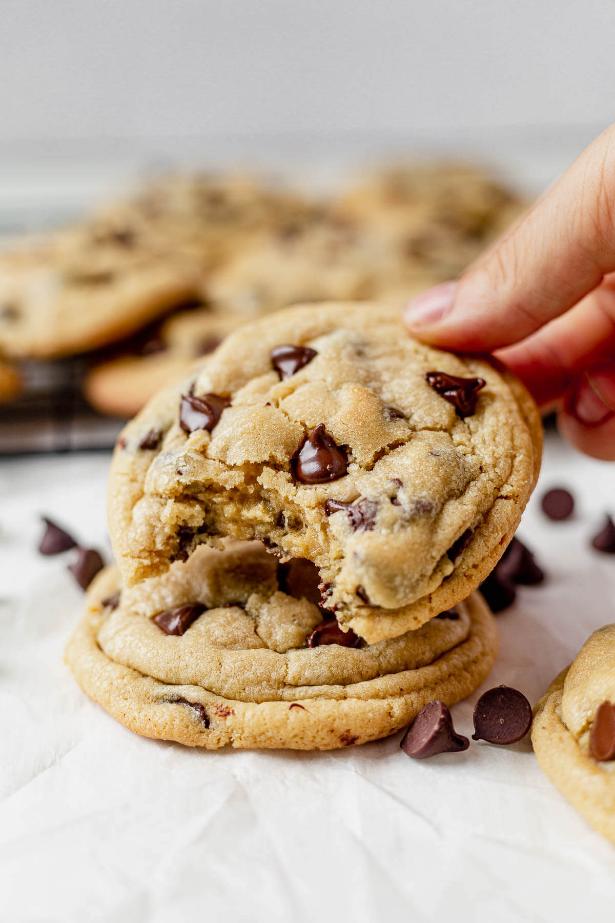 two chocolate chip pudding cookies stacked on top of each other with a bite taken out of the top one