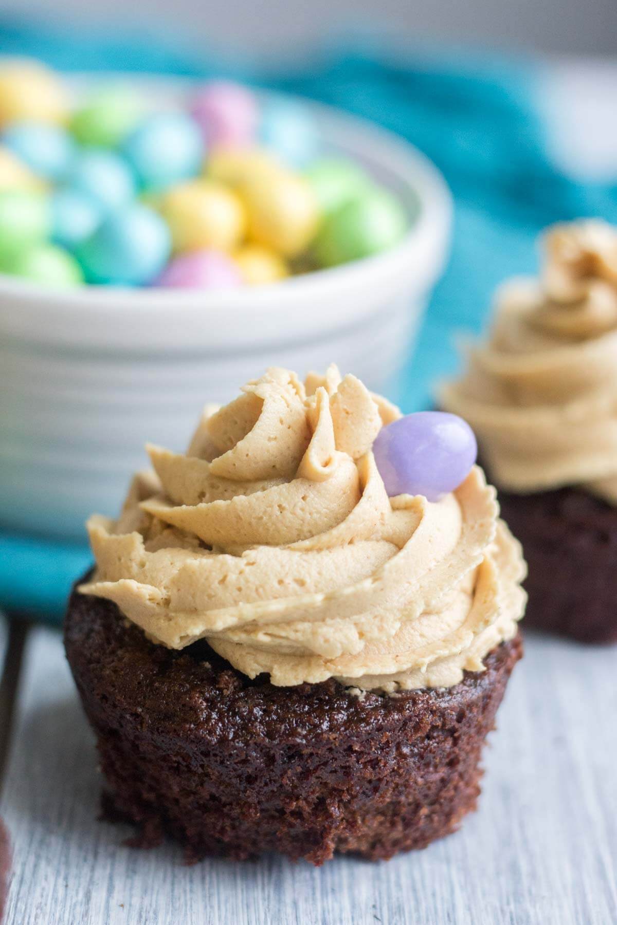 Light and fluffy chocolate cupcakes are topped with a sweet and creamy peanut butter frosting. Plus, there's a fun Easter surprise on the inside! These Chocolate Peanut Butter Piñata Cupcakes will surprise and delight all of your friends and family.