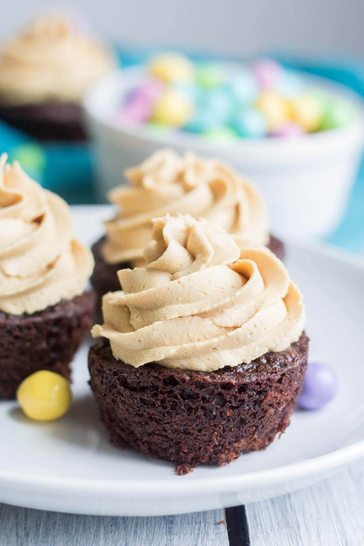 Light and fluffy chocolate cupcakes are topped with a sweet and creamy peanut butter frosting. Plus, there's a fun Easter surprise on the inside! These Chocolate Peanut Butter Piñata Cupcakes will surprise and delight all of your friends and family.