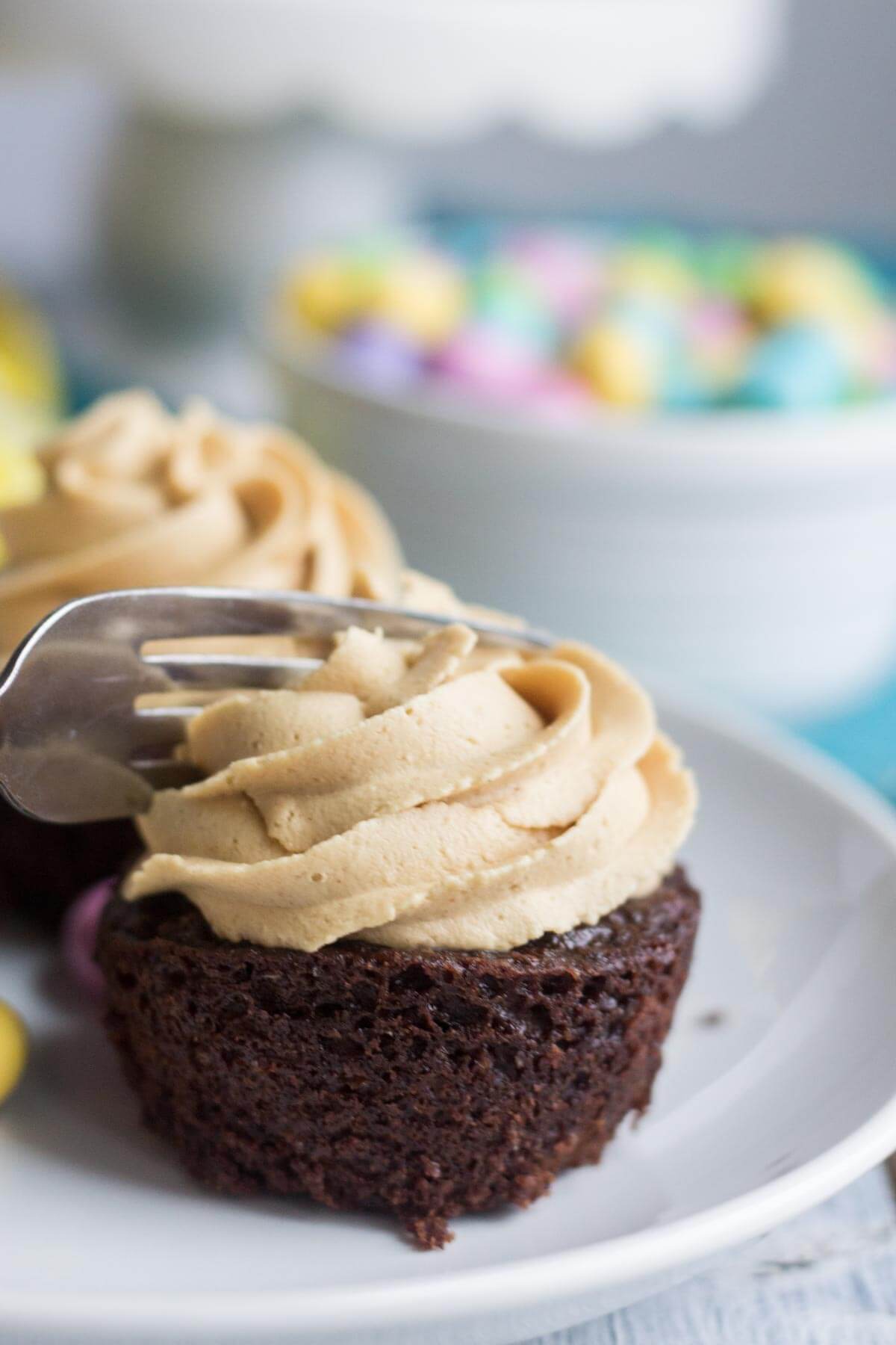 Light and fluffy chocolate cupcakes are topped with a sweet and creamy peanut butter frosting. Plus, there's a fun Easter surprise on the inside! These Chocolate Peanut Butter Piñata Cupcakes will surprise and delight all of your friends and family.