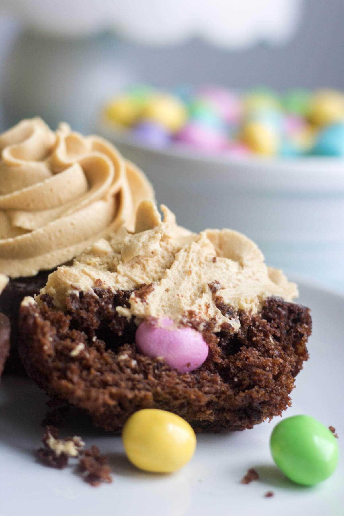 Light and fluffy chocolate cupcakes are topped with a sweet and creamy peanut butter frosting. Plus, there's a fun Easter surprise on the inside! These Chocolate Peanut Butter Piñata Cupcakes will surprise and delight all of your friends and family.