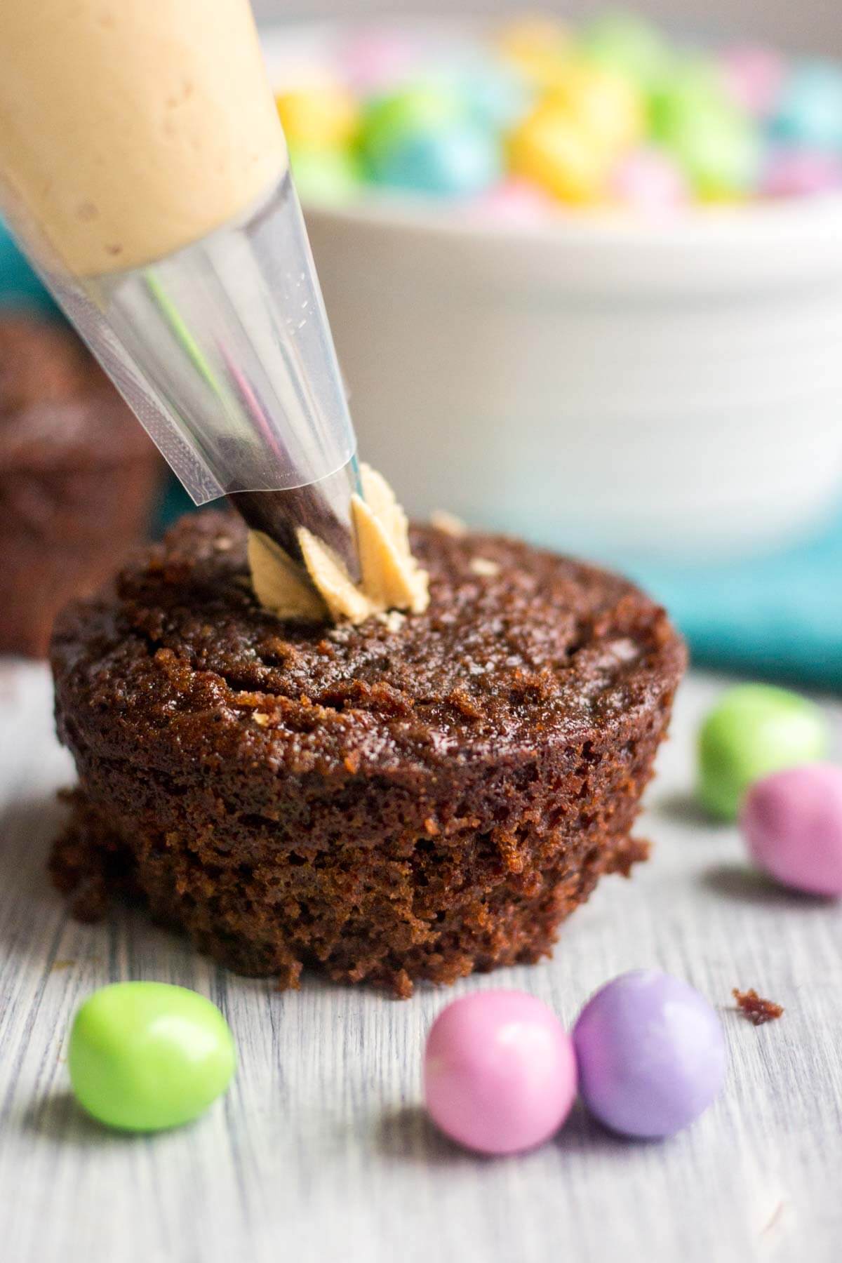 Light and fluffy chocolate cupcakes are topped with a sweet and creamy peanut butter frosting. Plus, there's a fun Easter surprise on the inside! These Chocolate Peanut Butter Piñata Cupcakes will surprise and delight all of your friends and family.