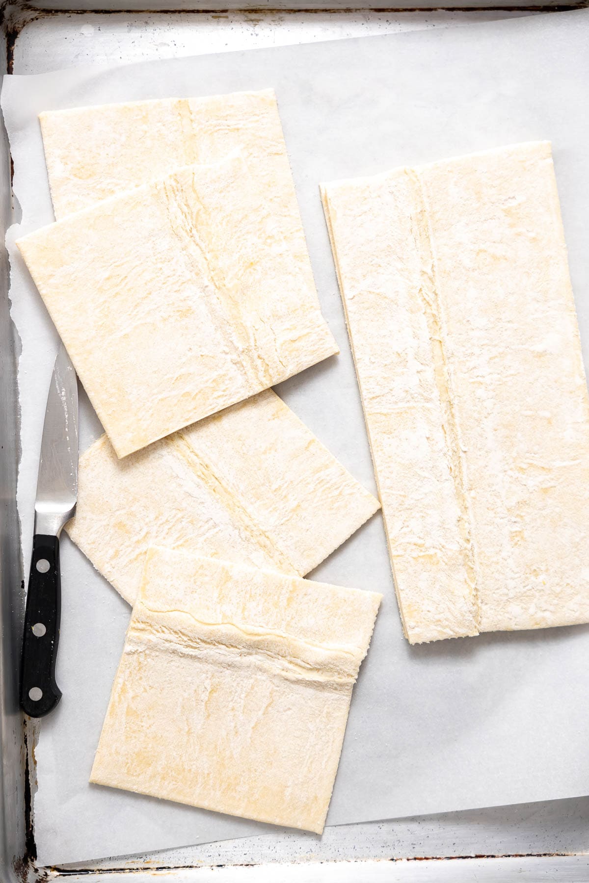 puff pastry cut into squares on parchment paper.