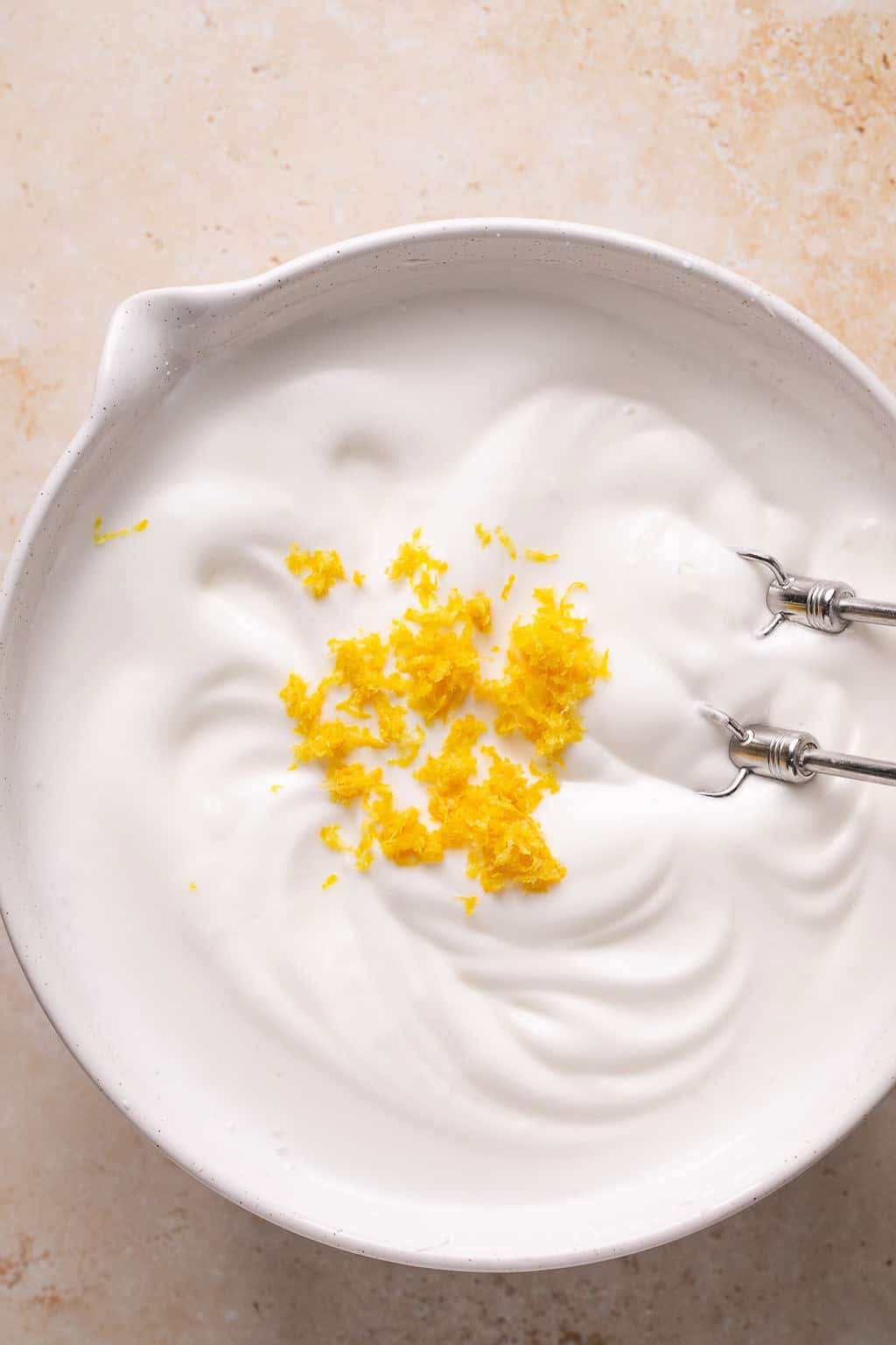 lemon zest on top of fluffy beaten egg whites
