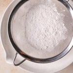 sifting dry ingredients into angel food cake batter