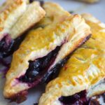 three blueberry turnovers stacked next to each other